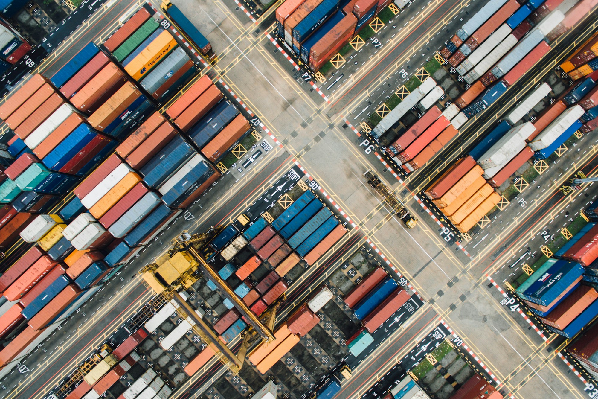 An aerial view of shipping containers arranged at a busy port
